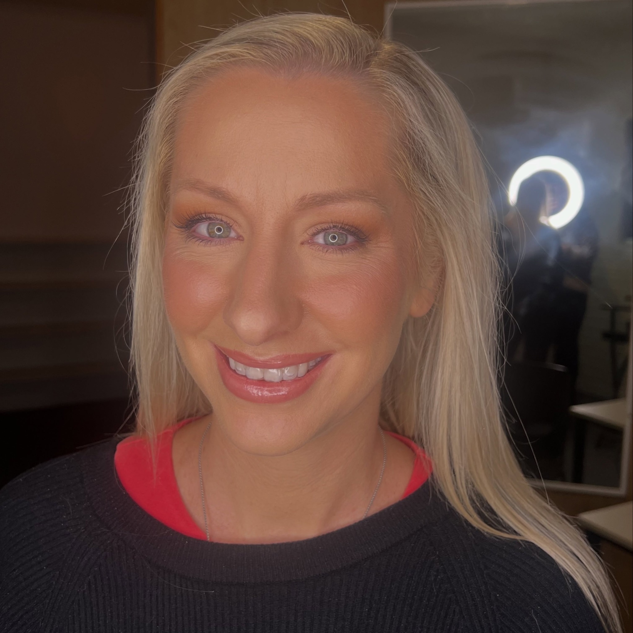 Smiling client after makeup in the studio