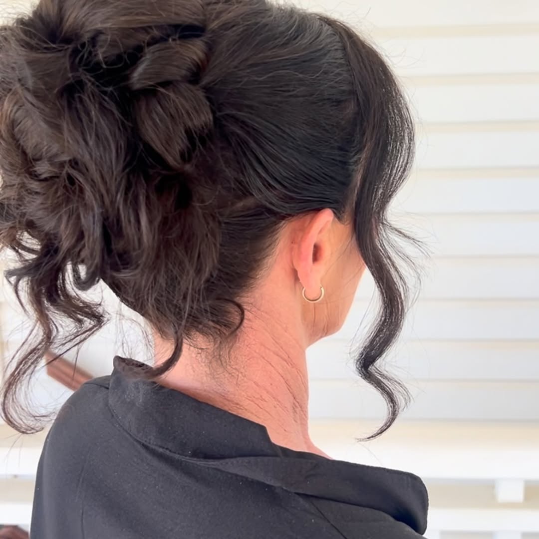 Textured bridal updo with face framing tendrils
